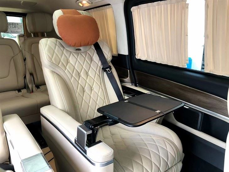 Folding table board installed on the armrest of individual seat in van 2